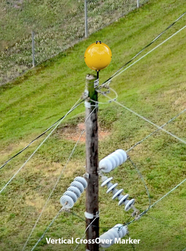 Vertical crossover marker shown at the top of a power line pole.