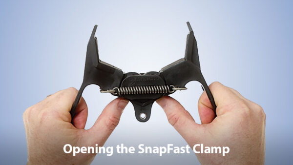 Photo showing two hands being used to open a SnapFast clamp.