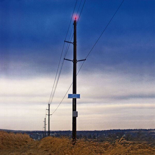 SunPOWR AIO solar obstruction light mounted to the to of a utility pole.