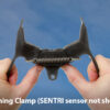 Photo showing a person opening a SENTRI clamp with their hands.