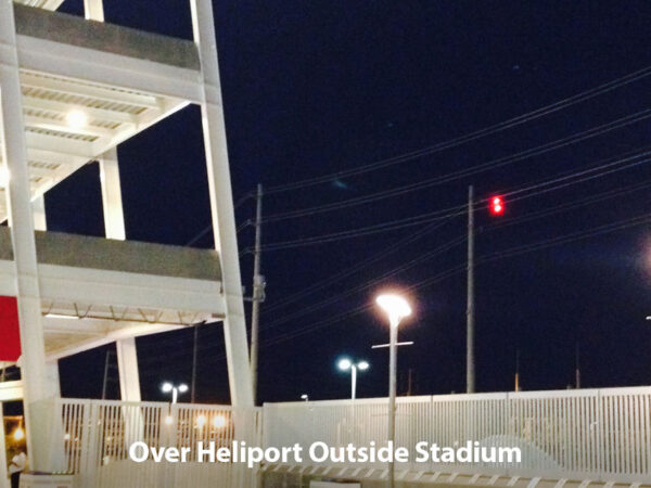 PoleLite on power line over heliport outside stadium.