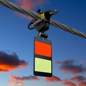 FireFly Ultra Bird Diverter shown mounted on a line with blue sky and clouds in the background.